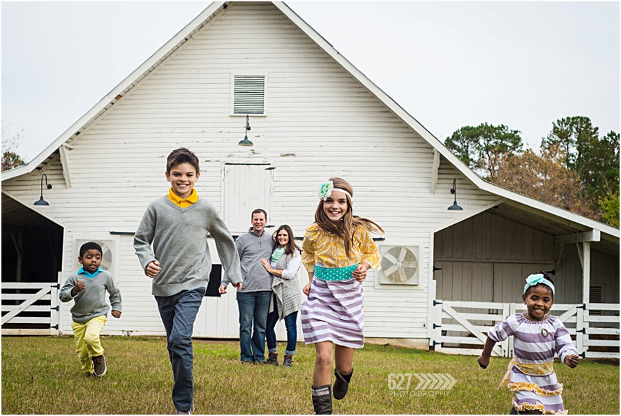 kids running in front of white barn