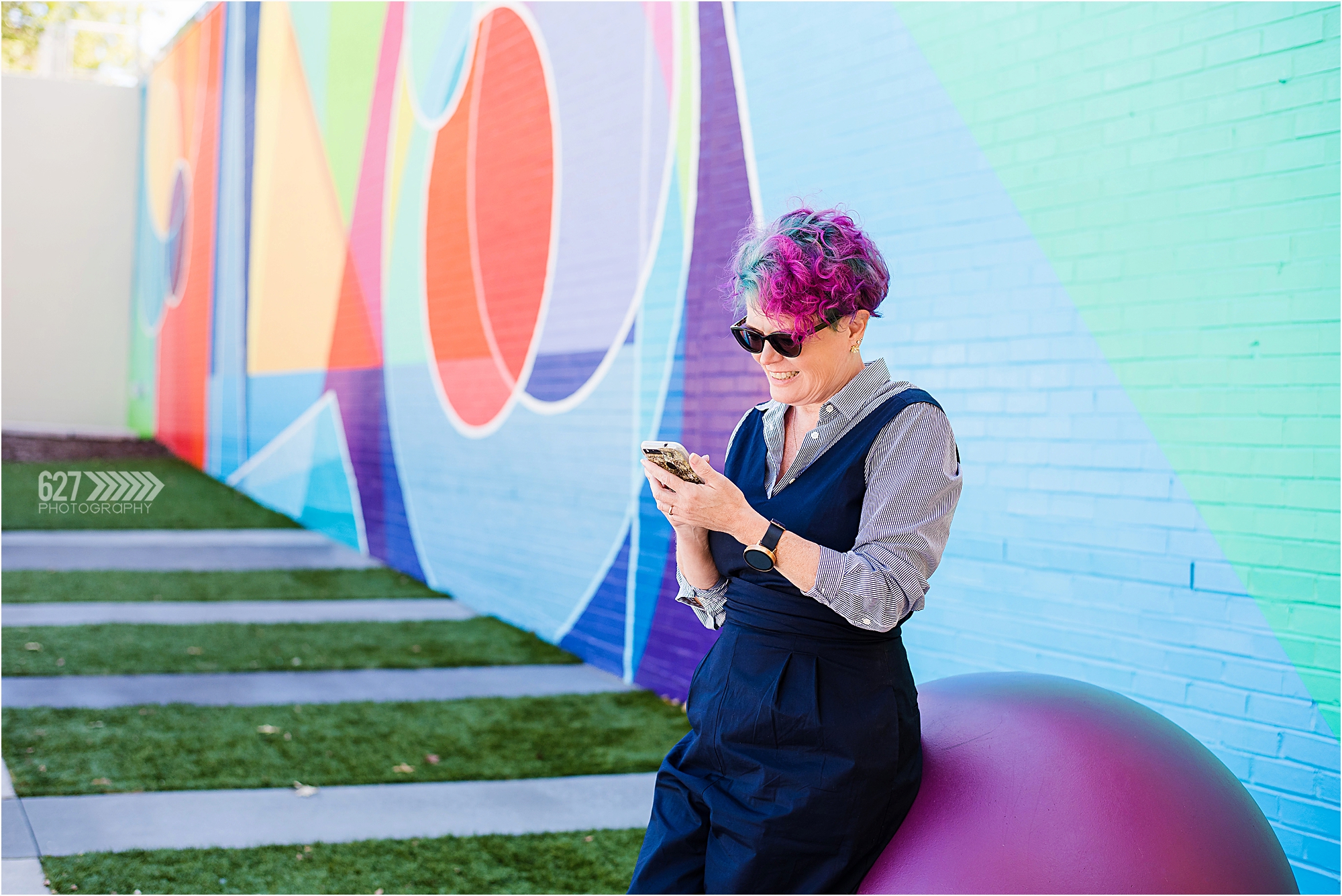 business branding photography for entrepreneurs colorful mural wall with iPhone