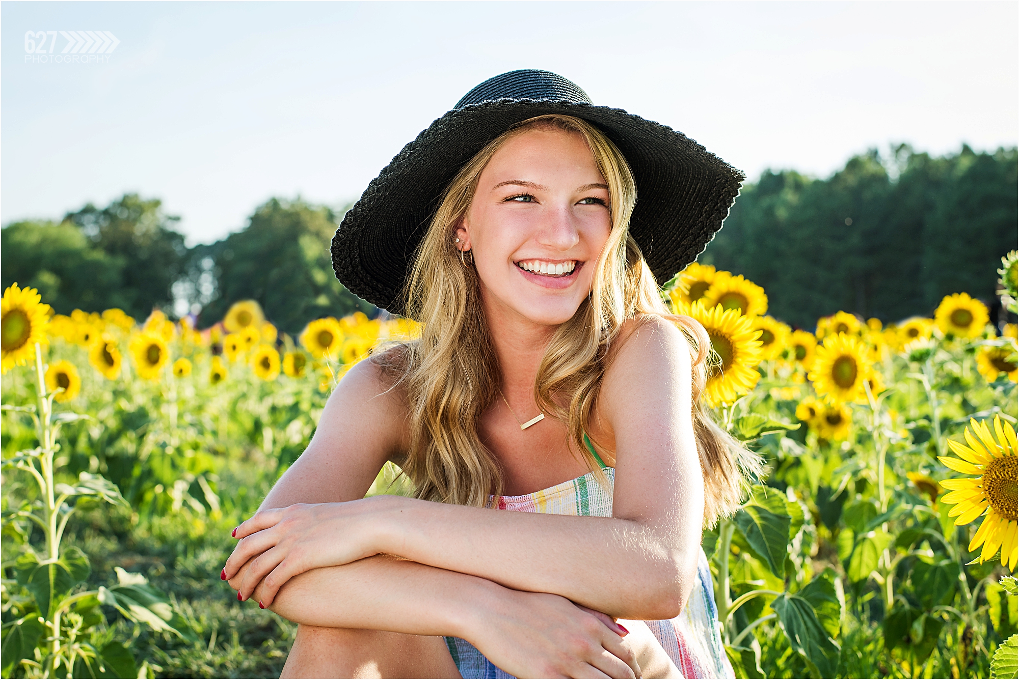 senior girls in sunflower field with hat