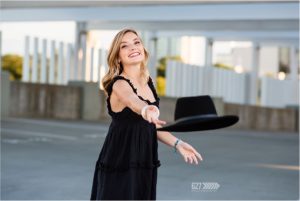 Senior girl tossing hat