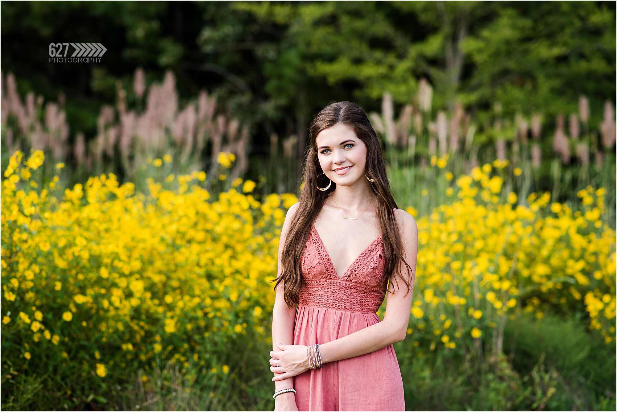 Senior girl in field of yellow flowers