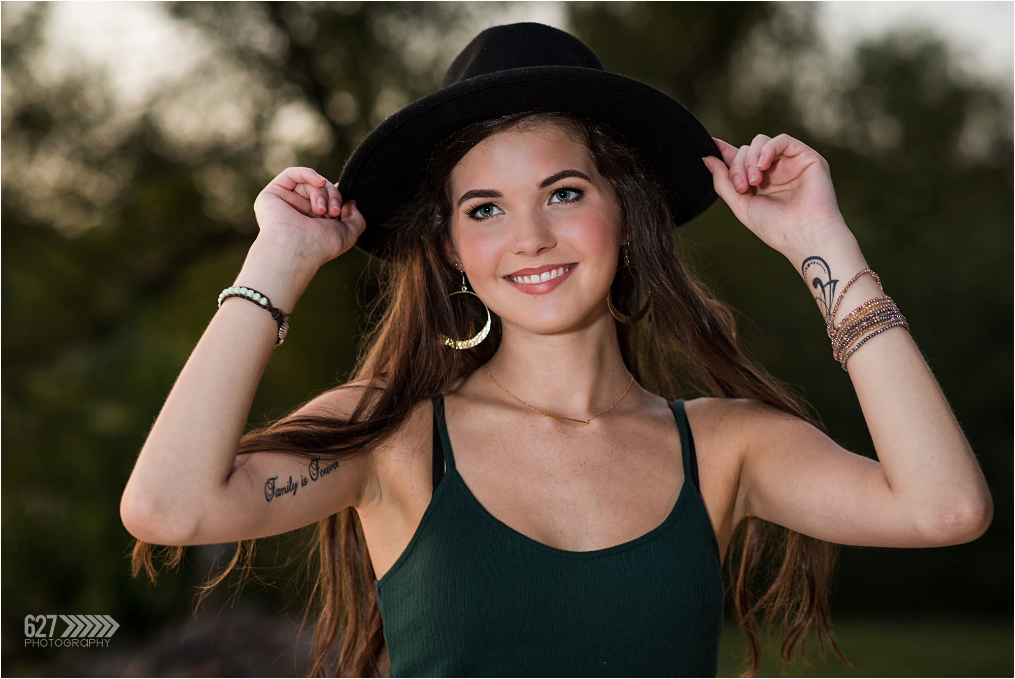 Senior girl in black hat with tattoos
