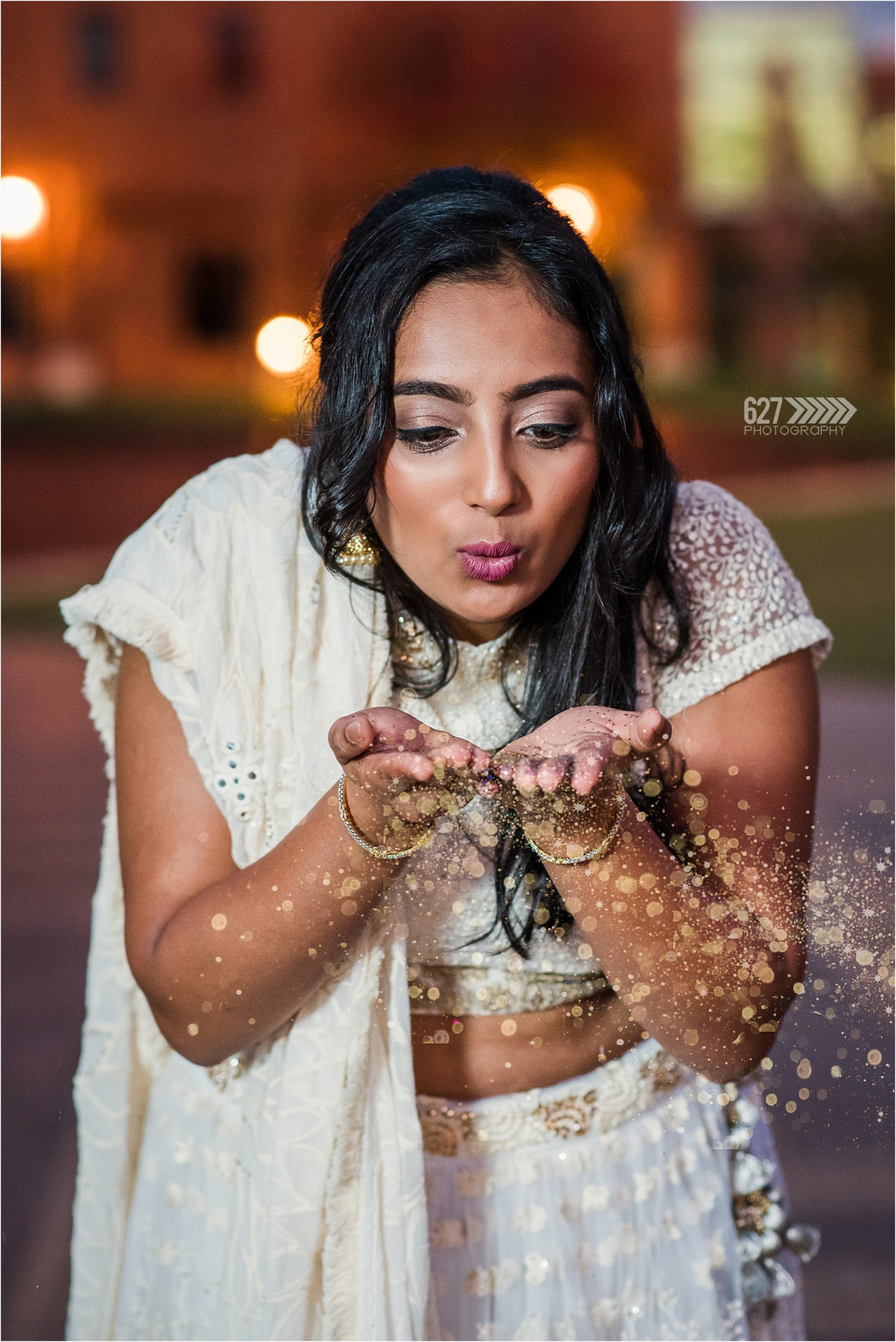 college grad portrait blowing glitter