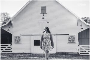 senior girl in front of barn