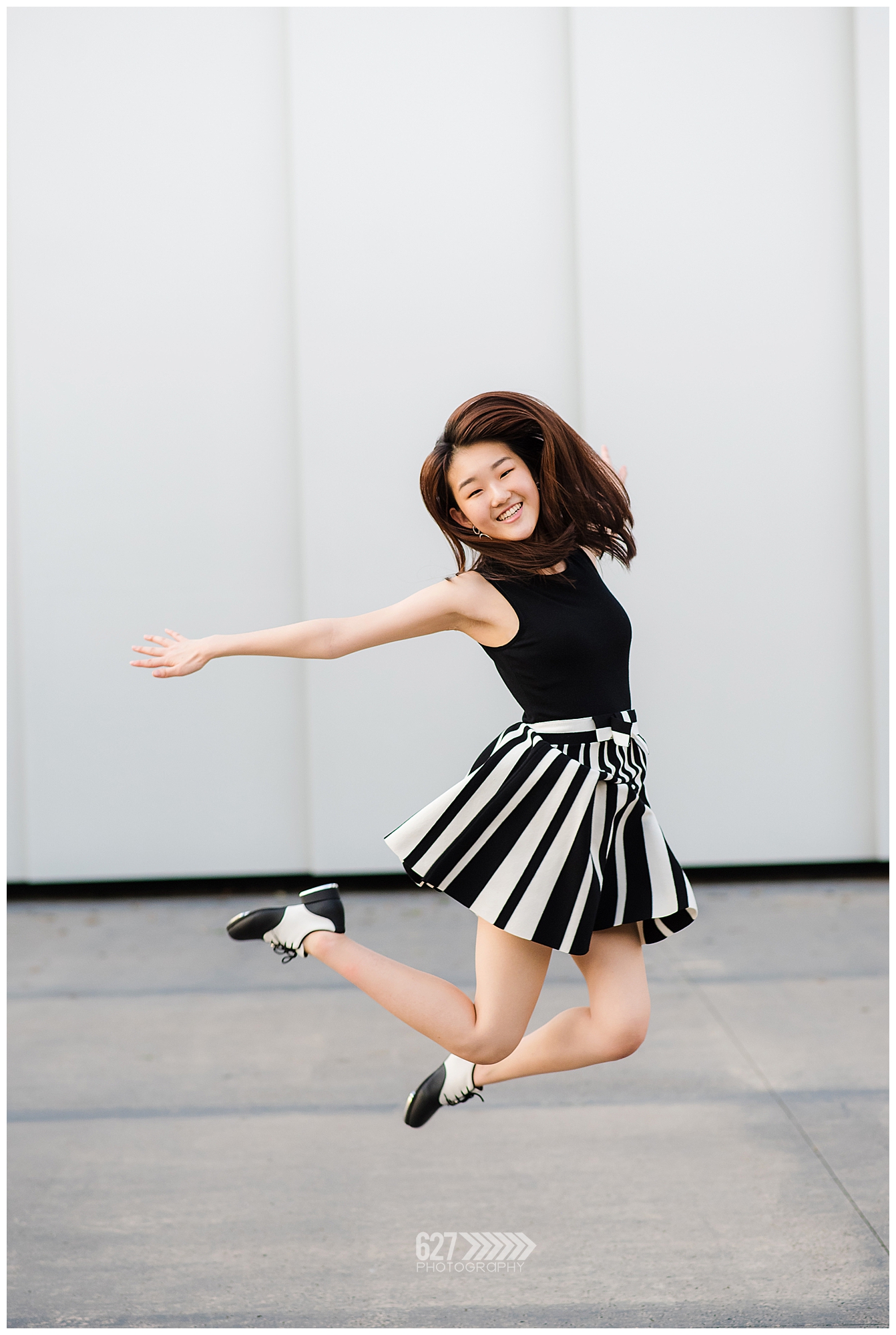 Senior girl with tap shoes jumping