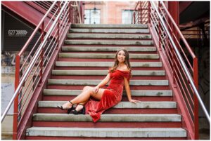 Senior girl at American Tobacco Campus in Velvet Dress on steps