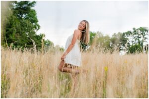 High school senior girl in golden tall grass field