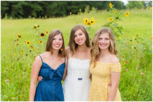 Triplet senior girls in wildflower fields