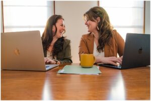 Therapists brainstorming and working on a laptop during a collaborative Raleigh branding shoot