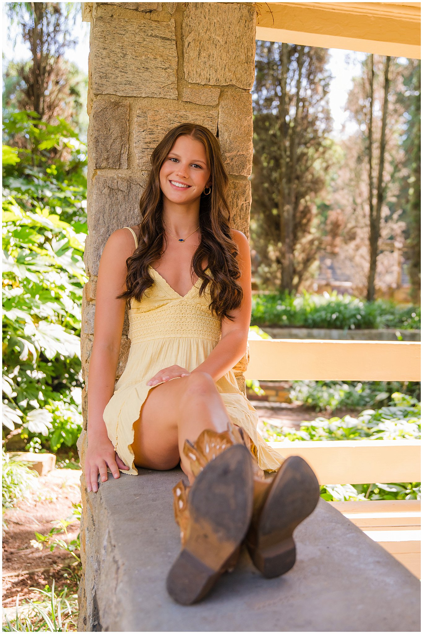 senior girl in cowboy boots and yellow dress