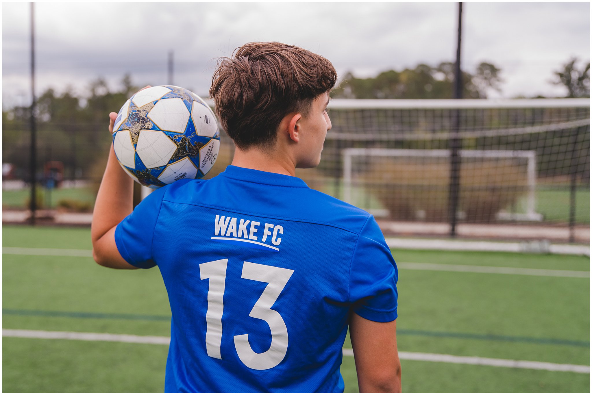 Senior photos of high school guy on soccer field in Apex North Carolina