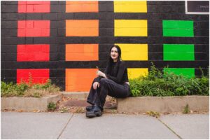 Panther Creek High School Class of 2026 senior portrait of Ava in downtown Raleigh with rainbow mural
