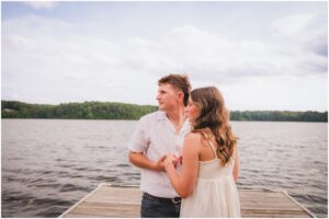 Couple portrait of Emilee and Wesley on the dock at Lake Wheeler