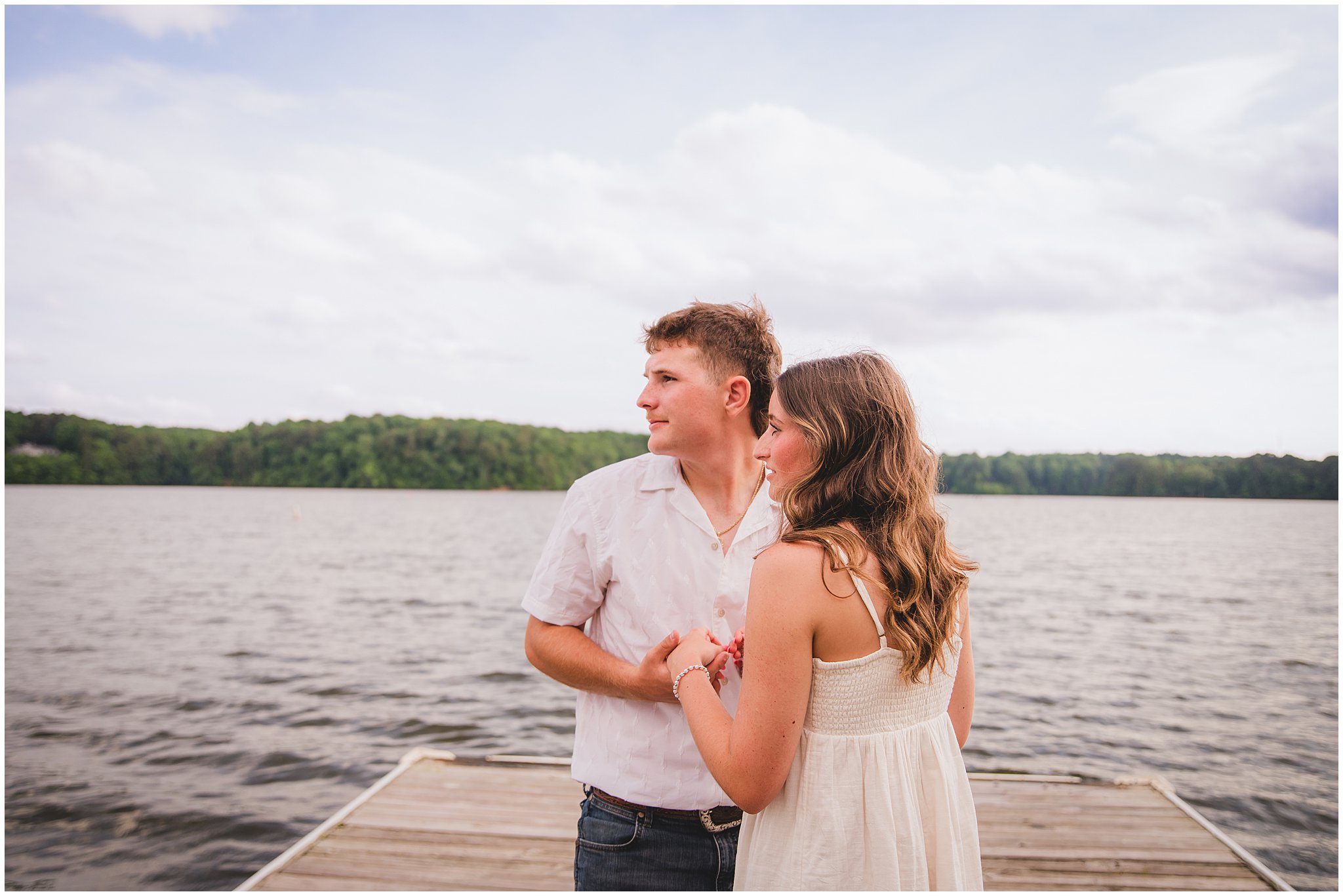 Couple portrait of Emilee and Wesley on the dock at Lake Wheeler