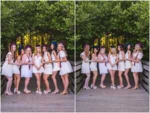 Seven Raleigh seniors wearing white dresses and graduation caps