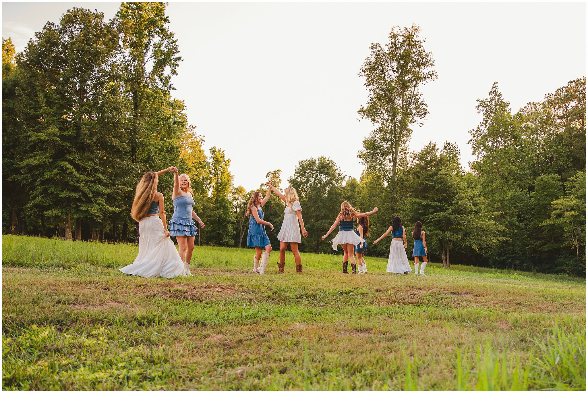Senior girls dancing together in a sunlit field